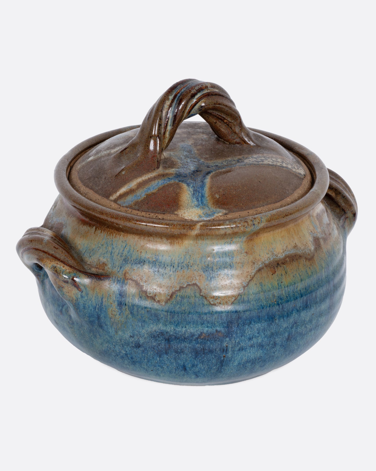 A ceramic pot with blue and brown glaze, dual handles, and a handled lid. Shown from the side.