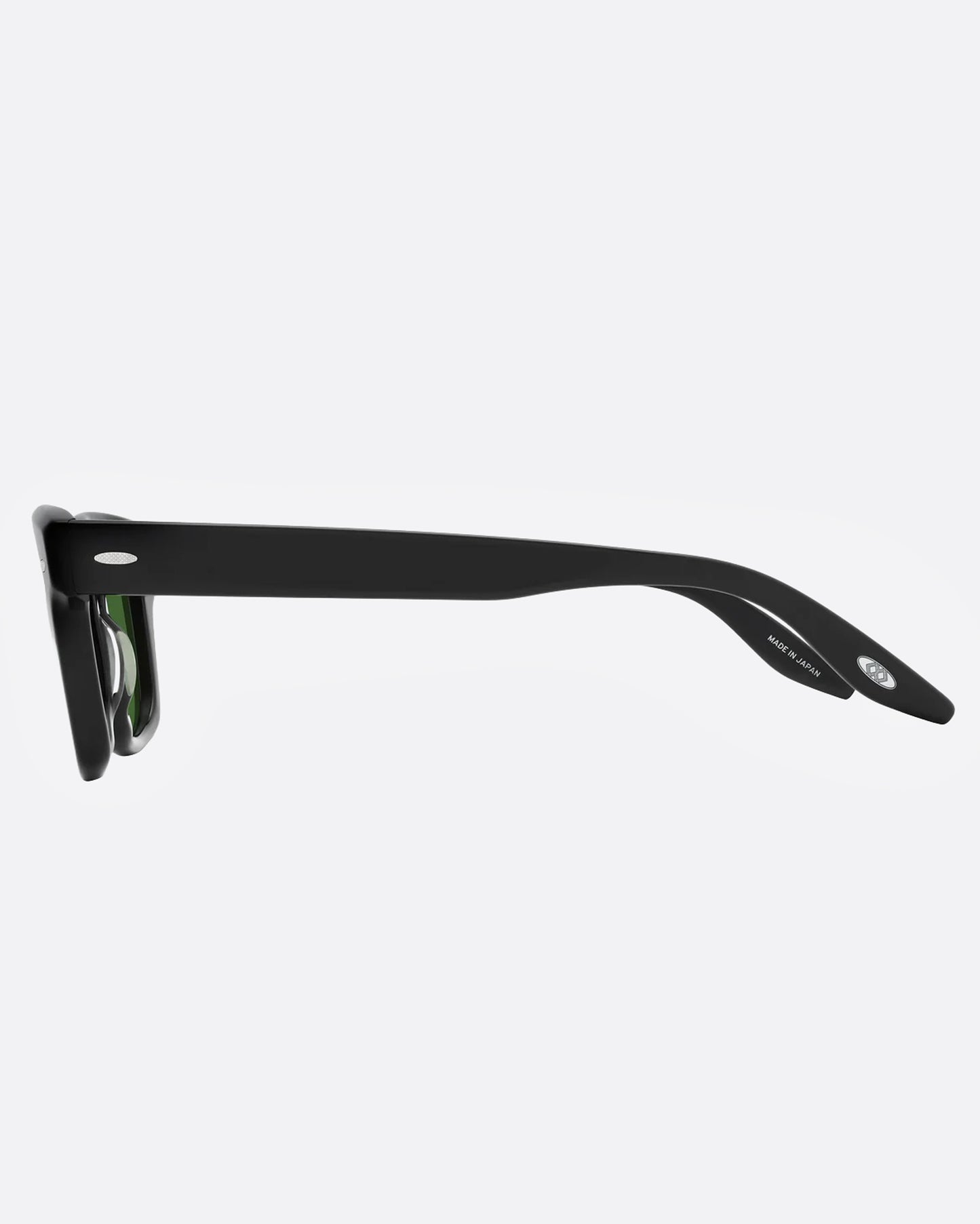 A pair of black sunglasses with green lenses, shown from the side.