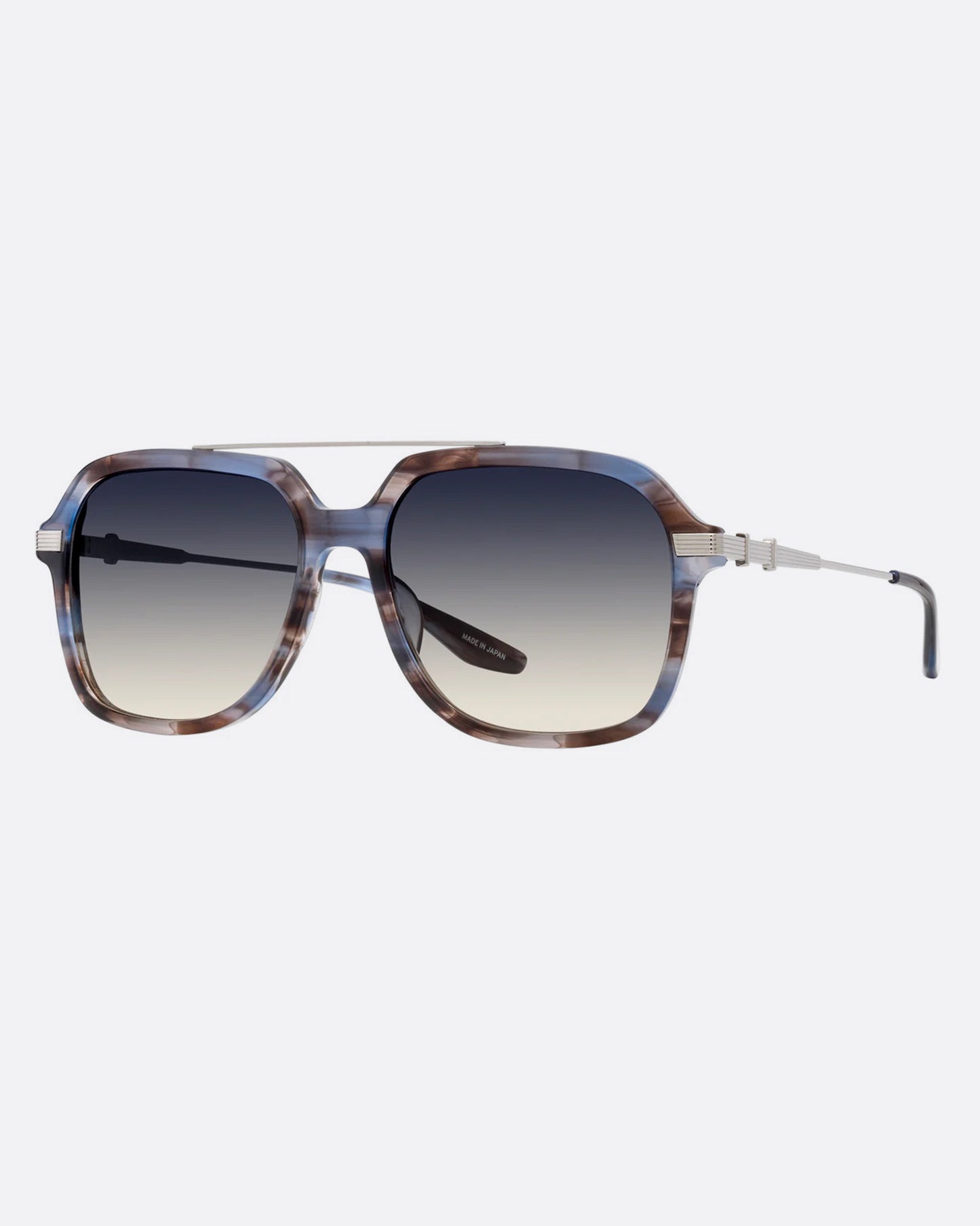 A pair of navigator sunglasses with pearly blue and silver structured frames and gray gradient lenses. Shown diagonally from the front.