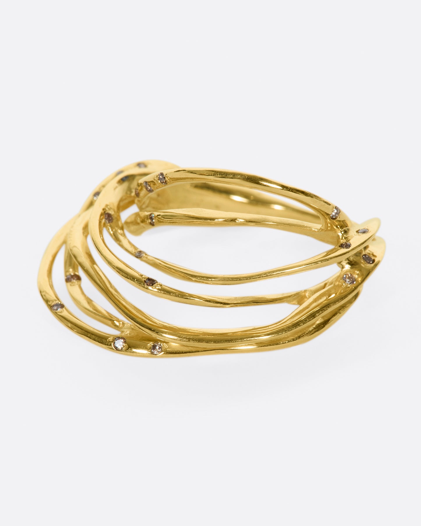 A yellow gold ring formed from multiple strands of gold, dotted with cognac diamonds. Shown from the side.