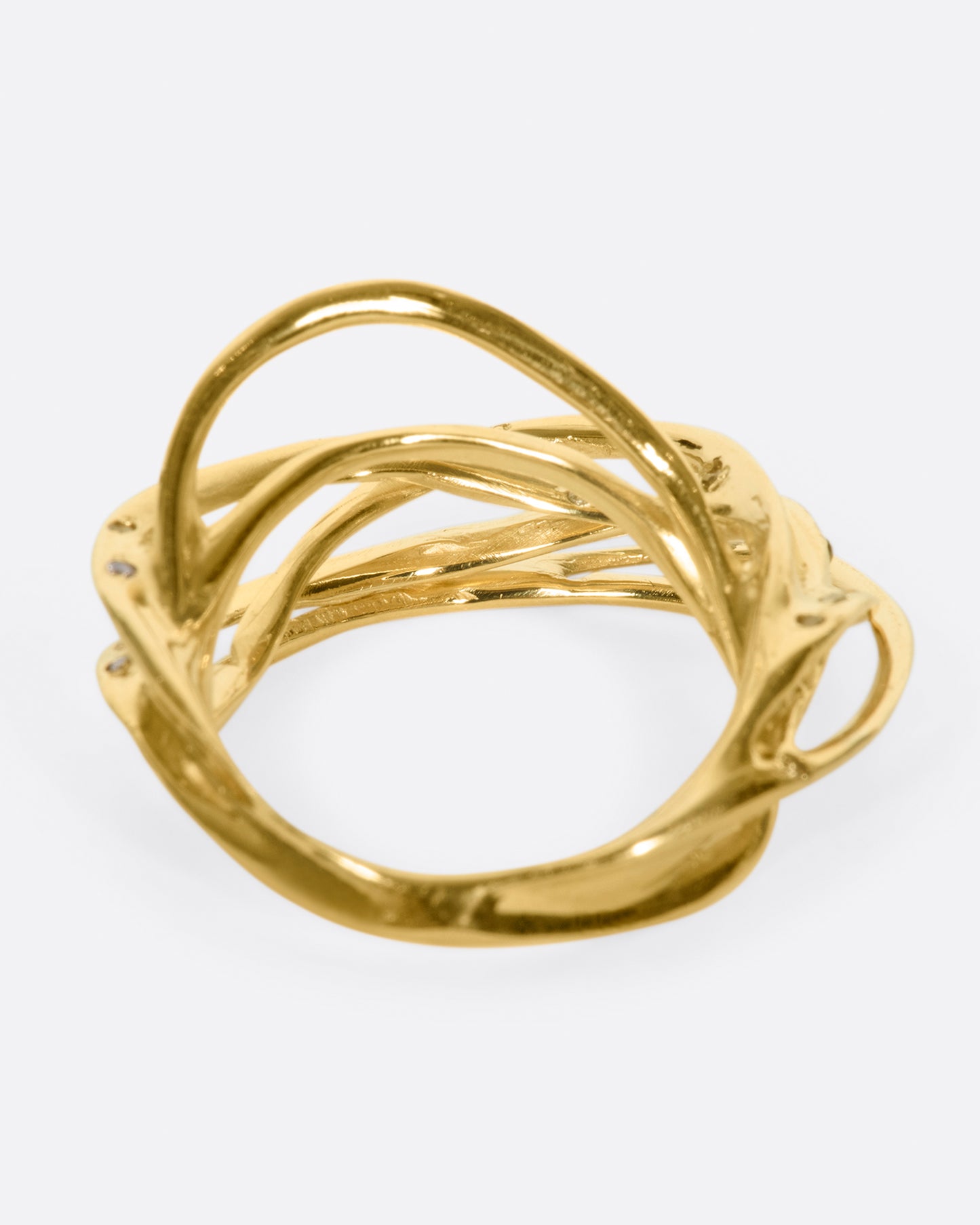 A yellow gold ring formed from multiple strands of gold, dotted with cognac diamonds. Shown from the back.