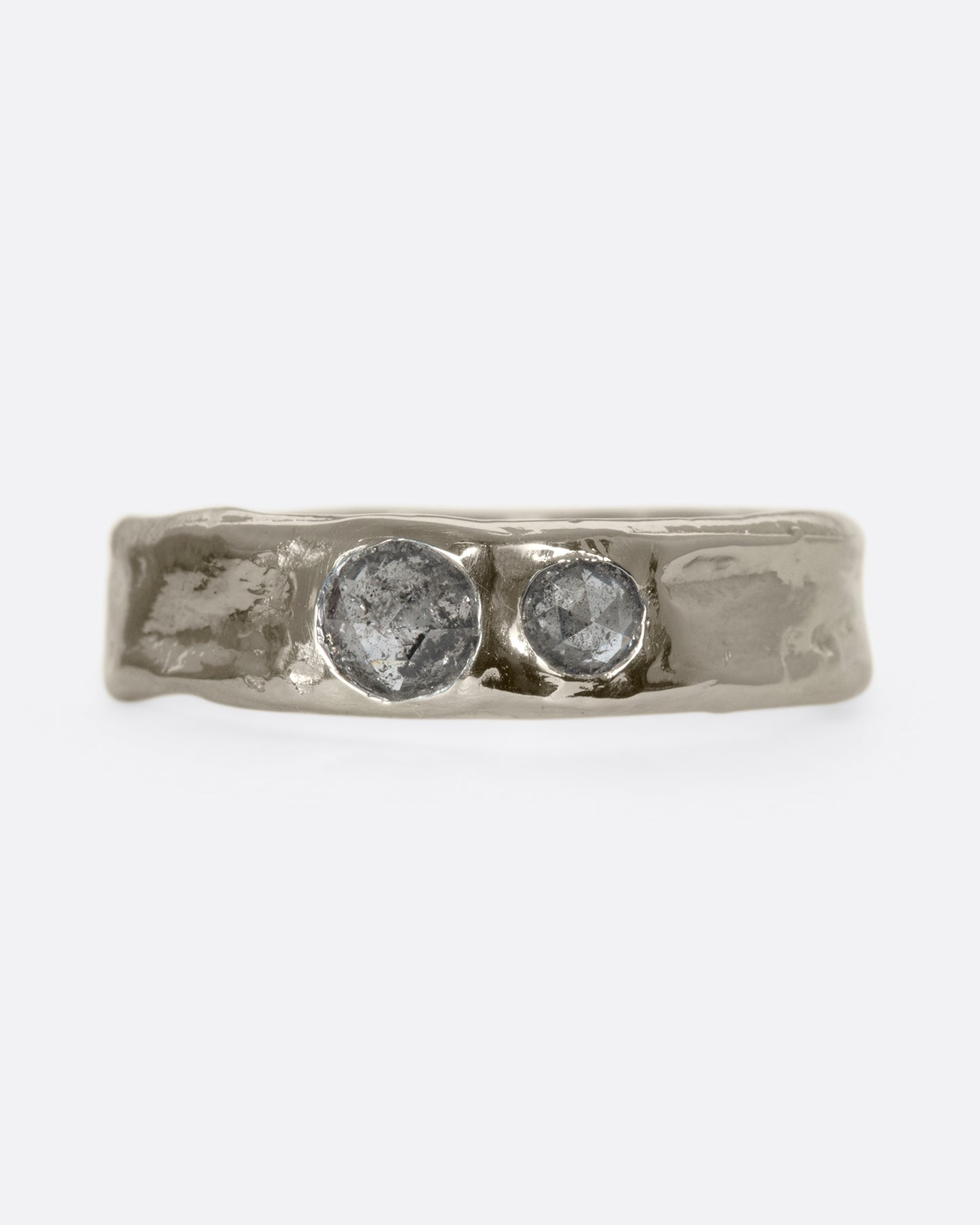 Medium wide band with light texture, featuring two rose cut salt & pepper diamonds flush to the band.