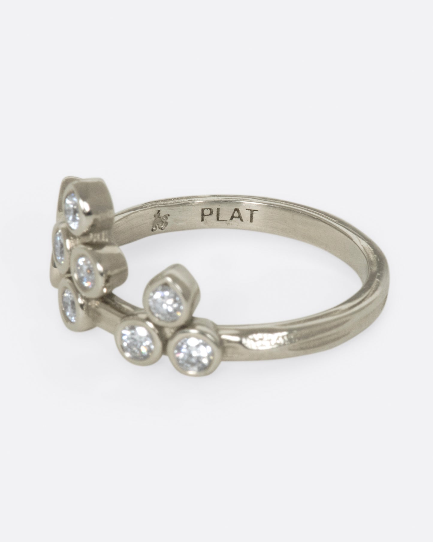 A tiara-like ring formed by 10 bezel-set round diamonds; wear it alone or stacked, and in either direction on the finger.
