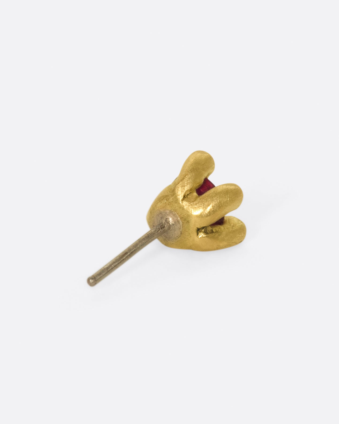 This earring is really about the ruby; large and saturated, it's a statement in itself.