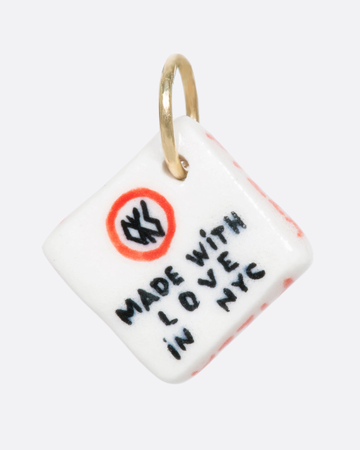 A white porcelain Classic New York pizza box charm with a yellow gold bail