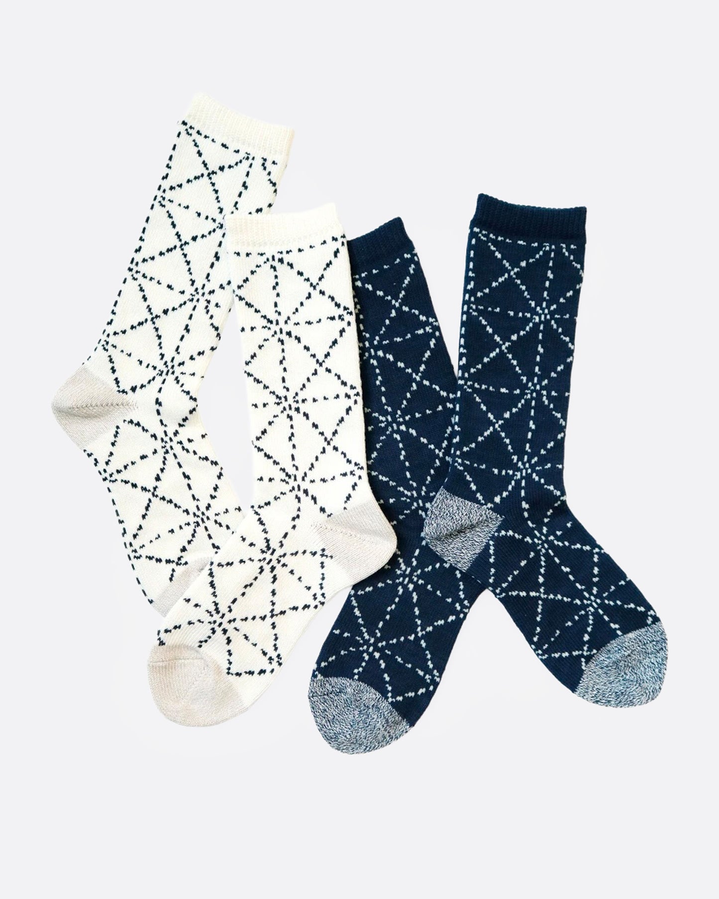 Two pairs of socks- one white and one navy with a Japanese sashiko print, shown from the side.
