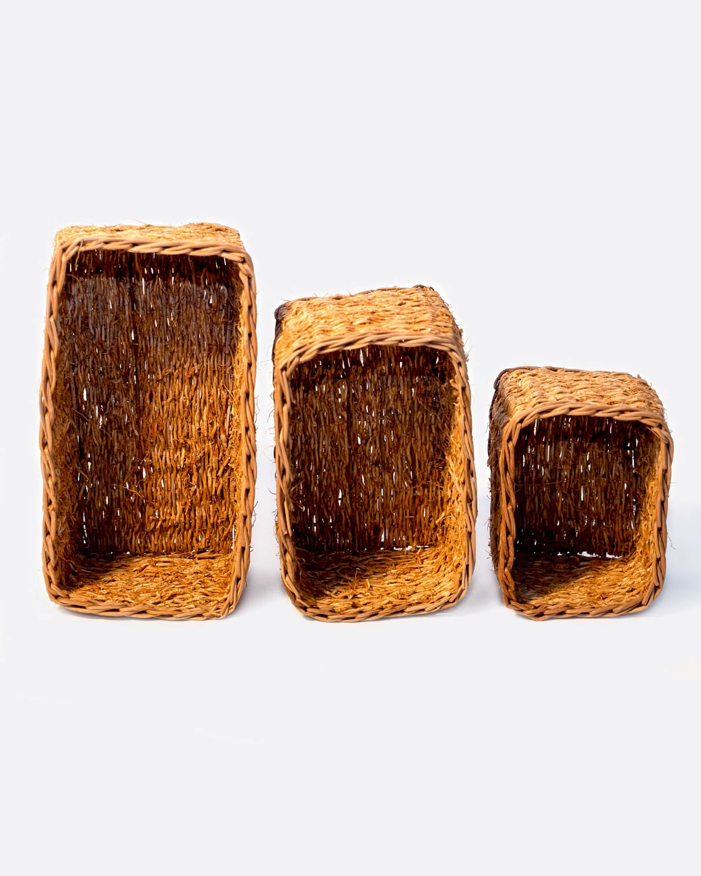 Three rectangular vetiver baskets in large, medium, and small sizes shown standing up side by side from the top.