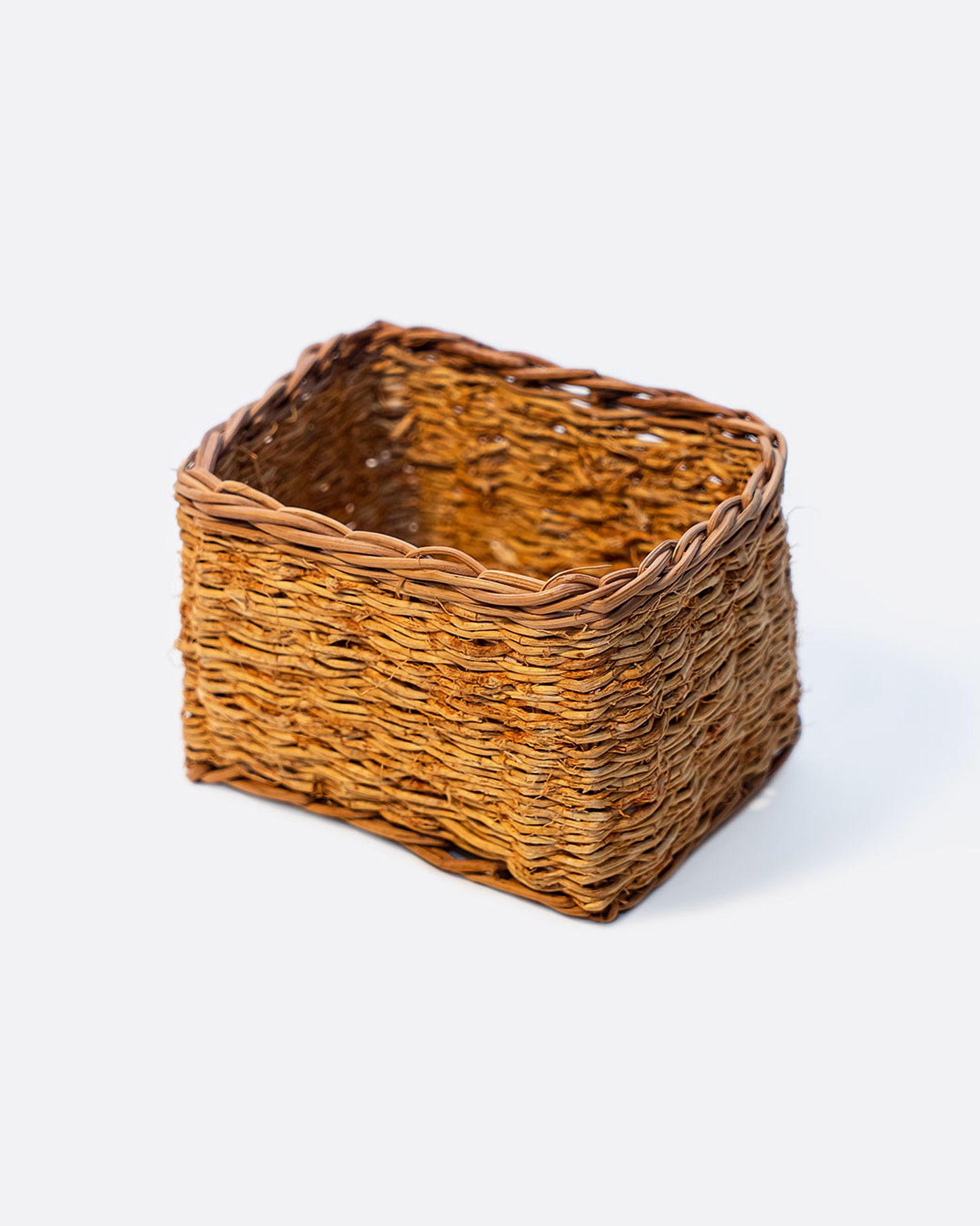 A rectangular vetiver basket shown at an angle from the side.