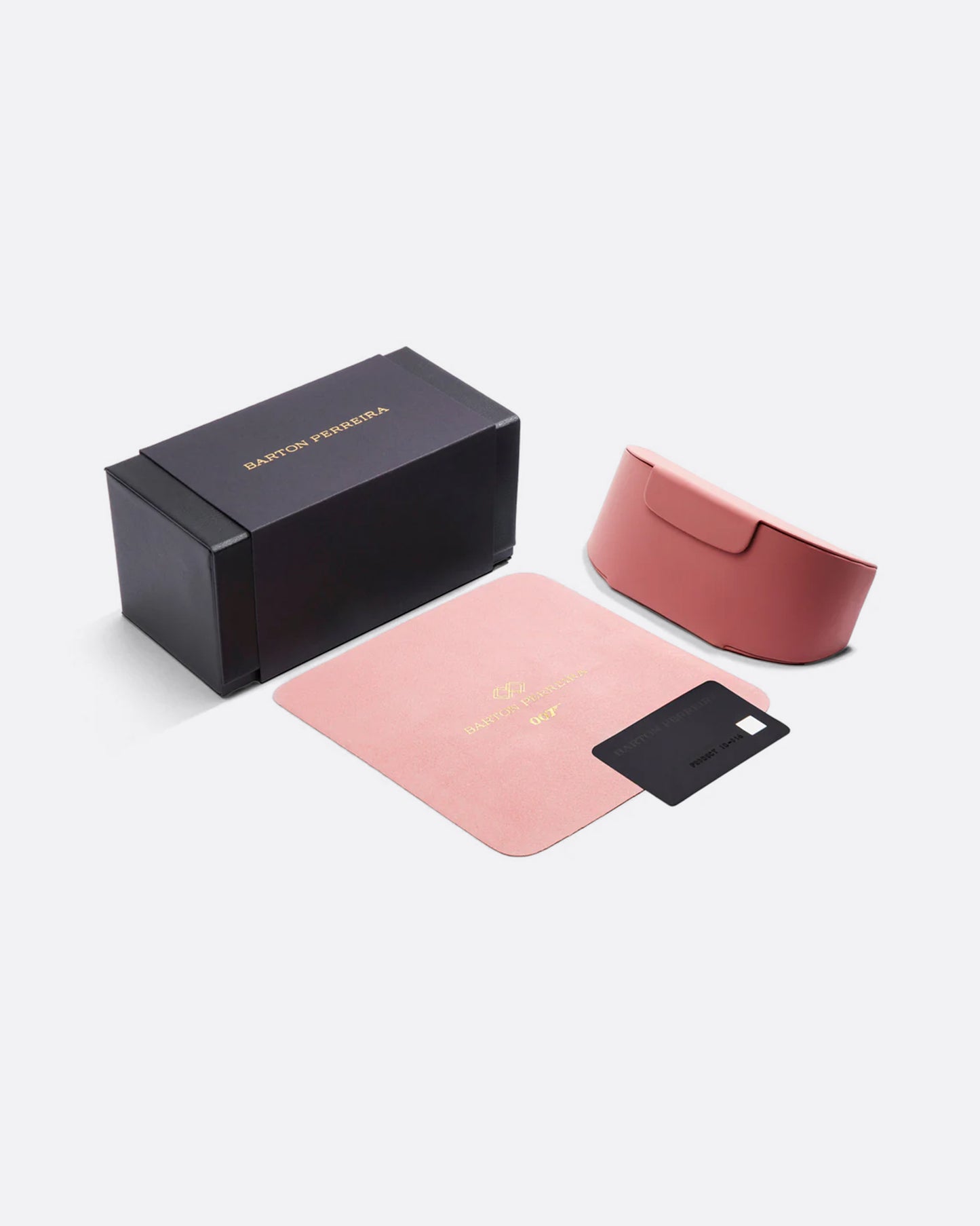 A black sunglass box, pink sunglass case, pink buffing cloth, and black card shown from the top.