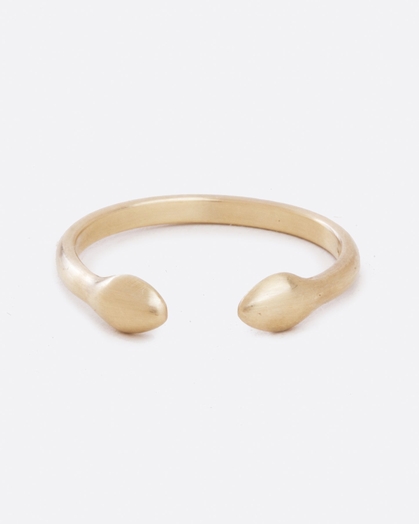 A yellow gold ring with an open front. The front pieces are more bulbous than the band. Shown from the front.