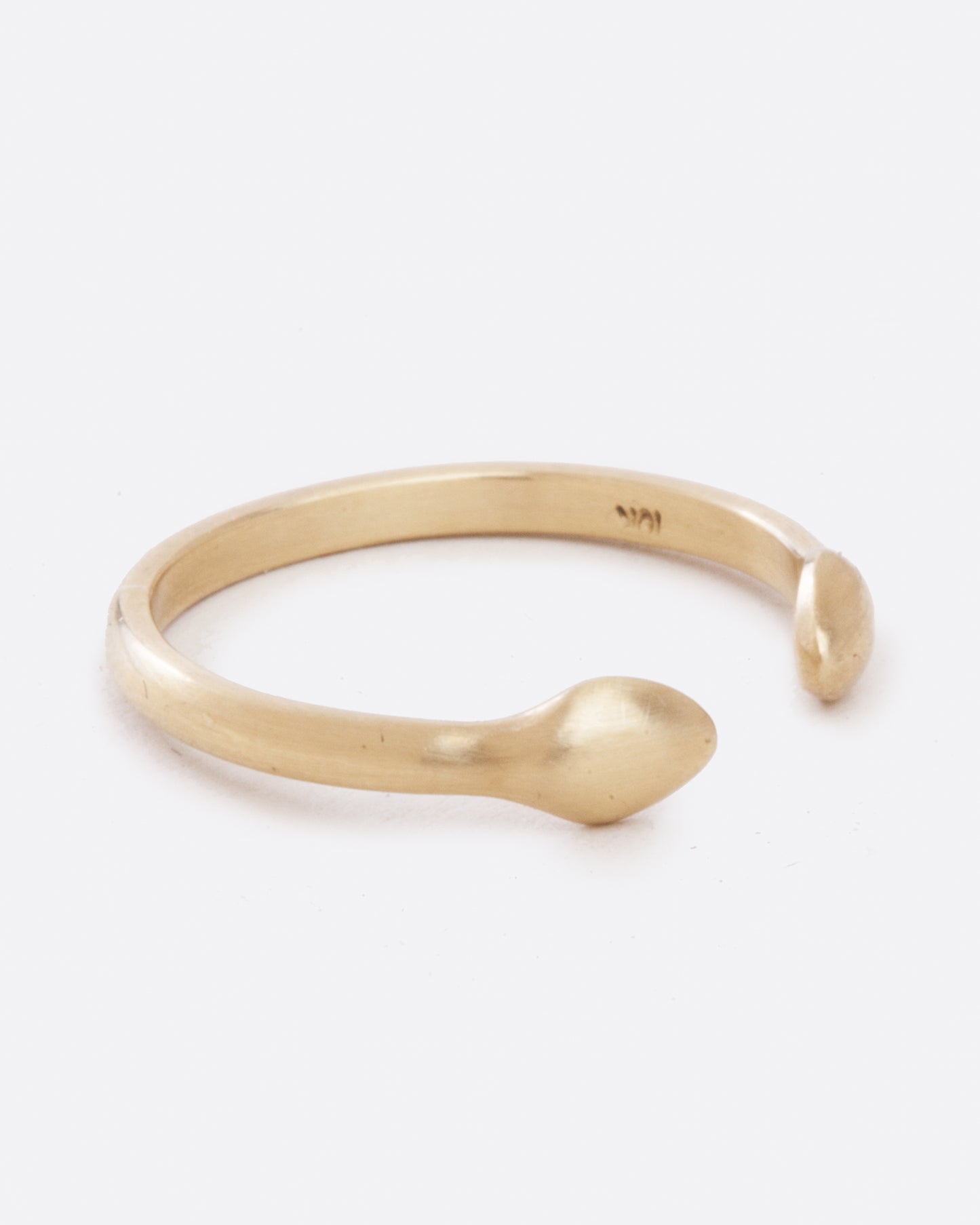 A yellow gold ring with an open front. The front pieces are more bulbous than the band. Shown from the side.