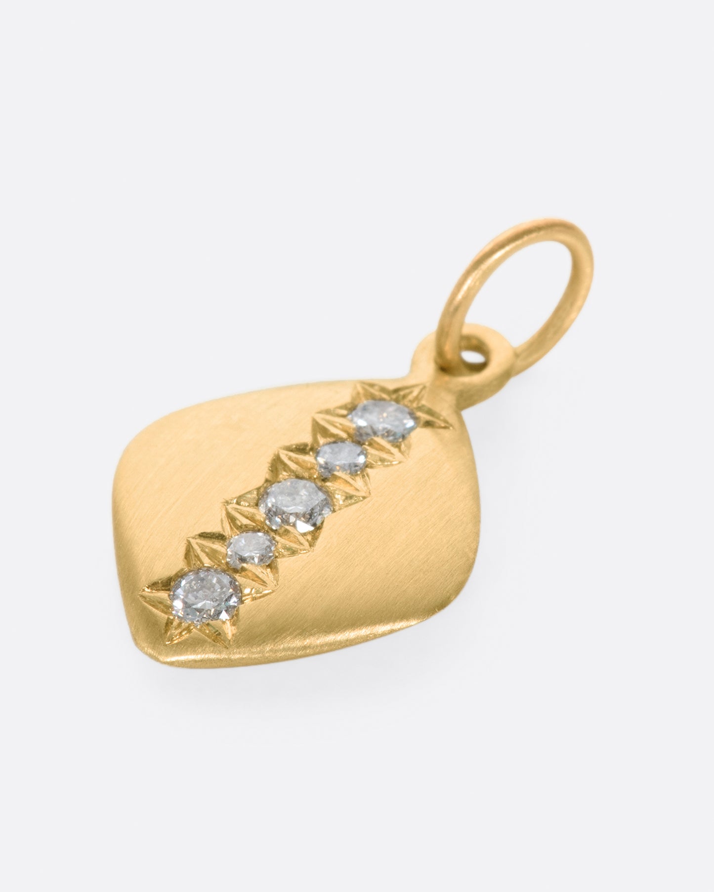 A rounded square tag, turned on its edge, with a line of gray diamonds down the center.