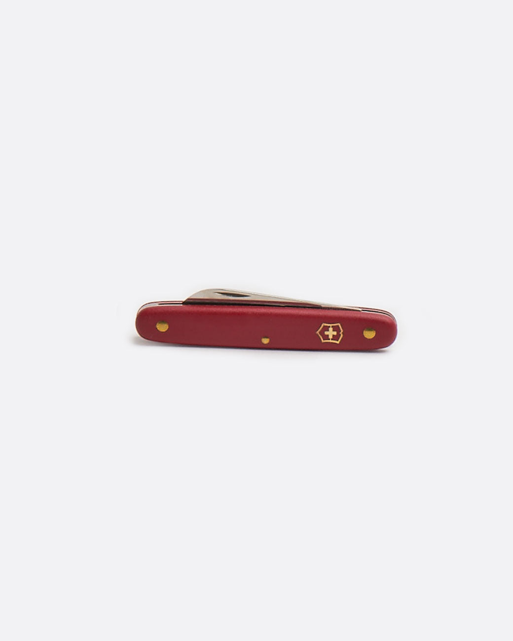 A Victorinox floral knife with red handle, shown closed from the side.