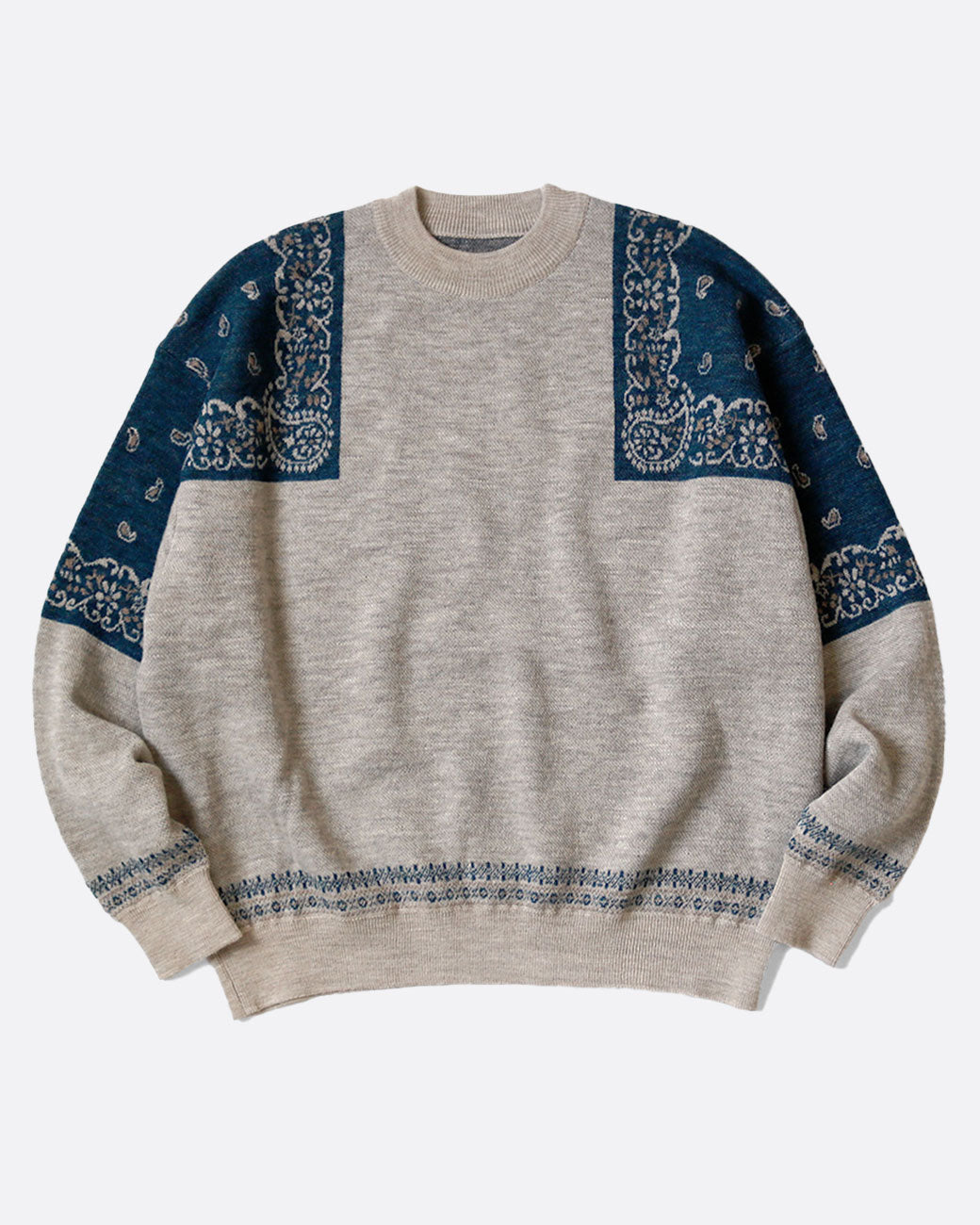 A gray crew neck sweater with navy bandana print on the shoulders. Shown from the front.