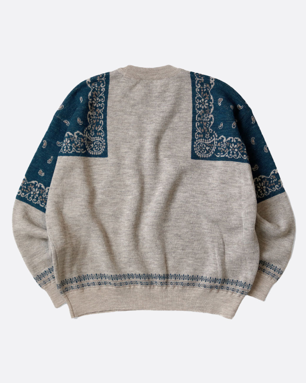 A gray crew neck sweater with navy bandana print on the shoulders. Shown from the back.