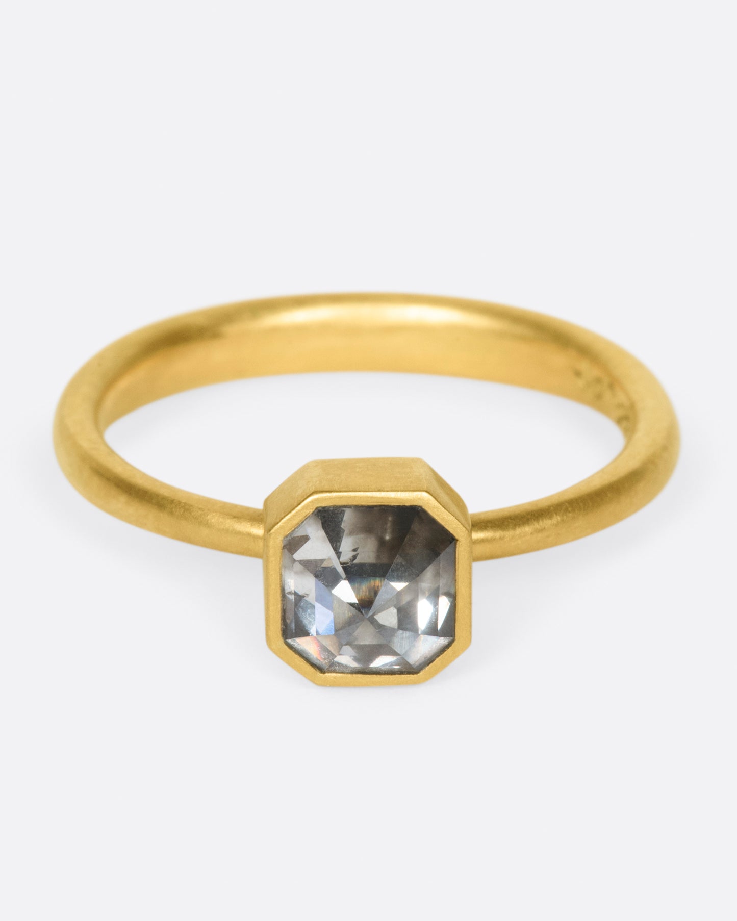 A yellow gold ring with a smokey octagonal diamond. Shown from the front.