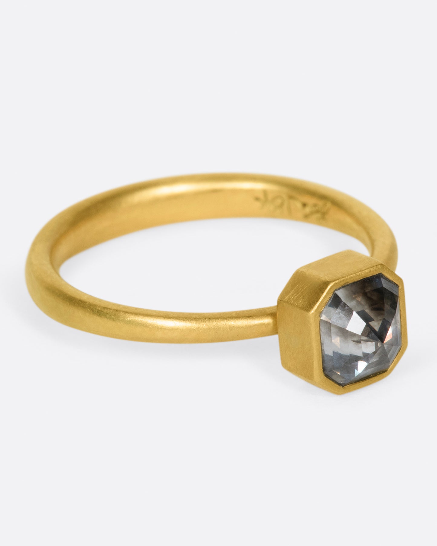 A yellow gold ring with a smokey octagonal diamond. Shown from the side.