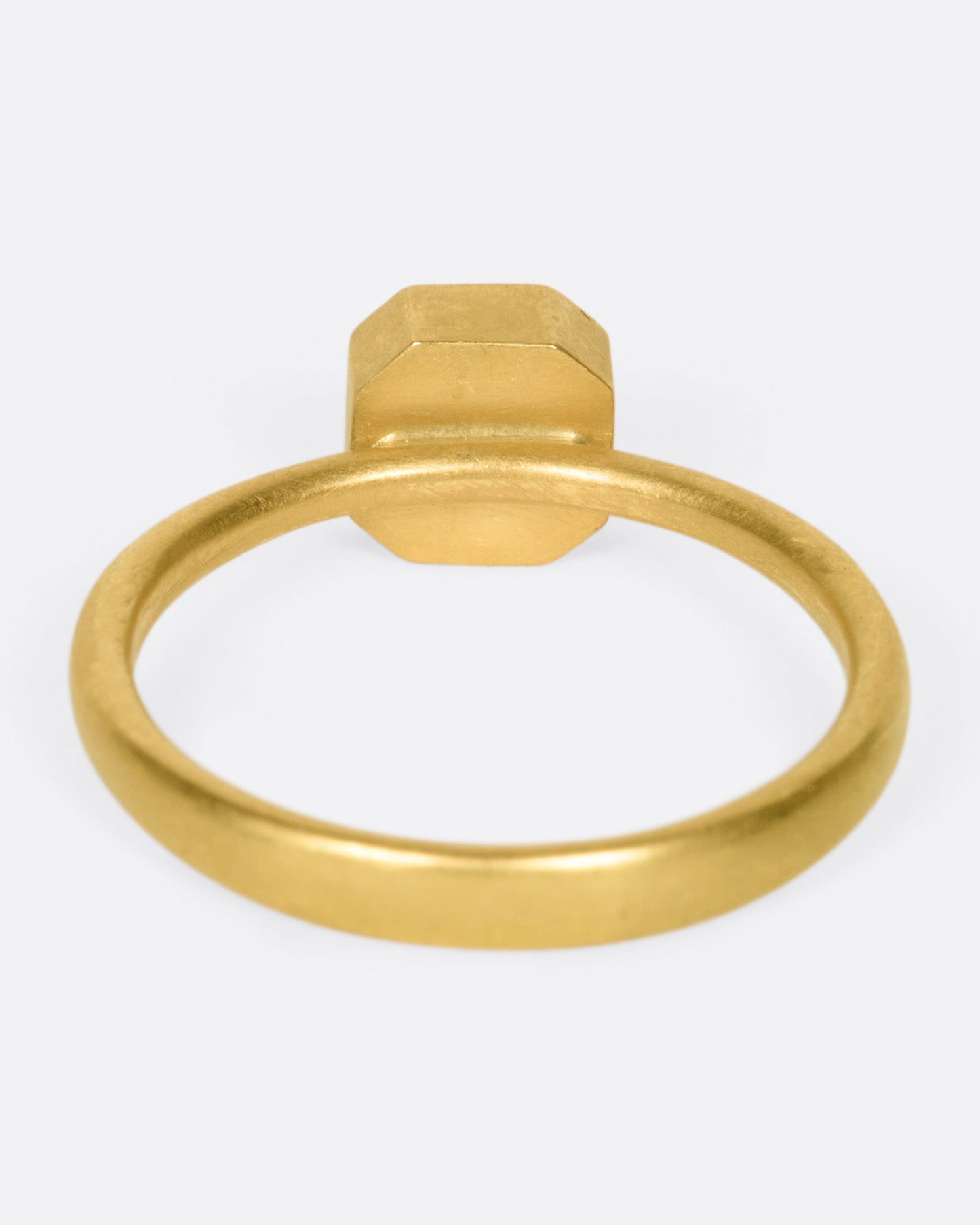 A yellow gold ring with a smokey octagonal diamond. Shown from the back.