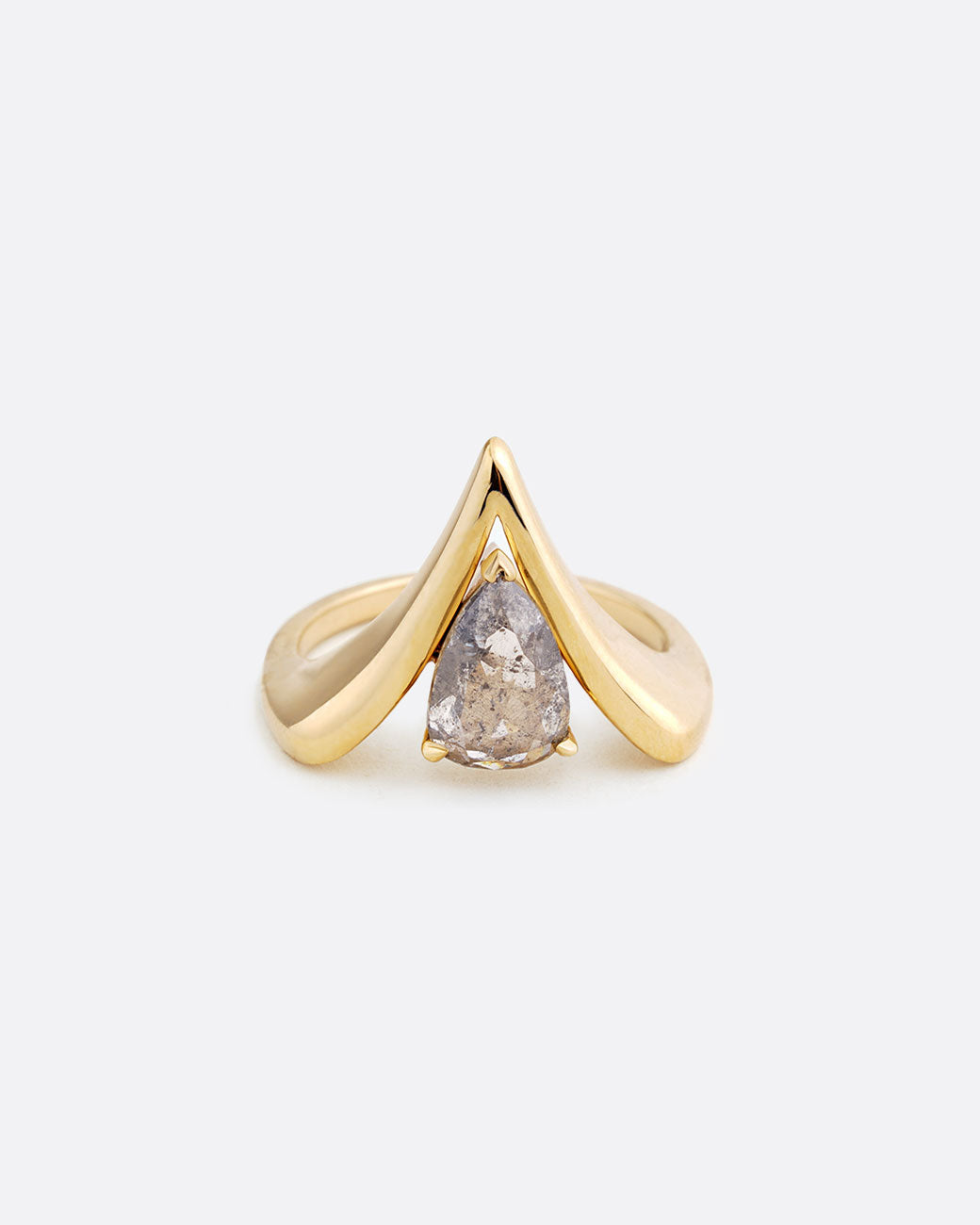 A yellow gold reversed V shaped ring with pear shaped salt and pepper diamond at the center. Shown from the front.