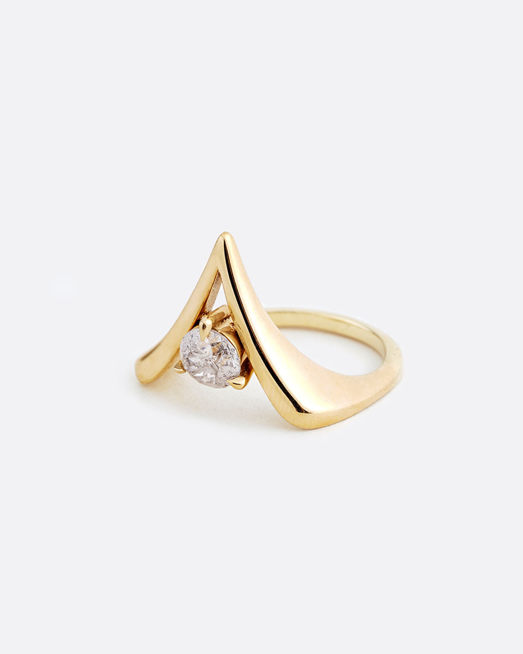 A yellow gold reversed V shaped ring with a diamond at the center. Shown from the side.