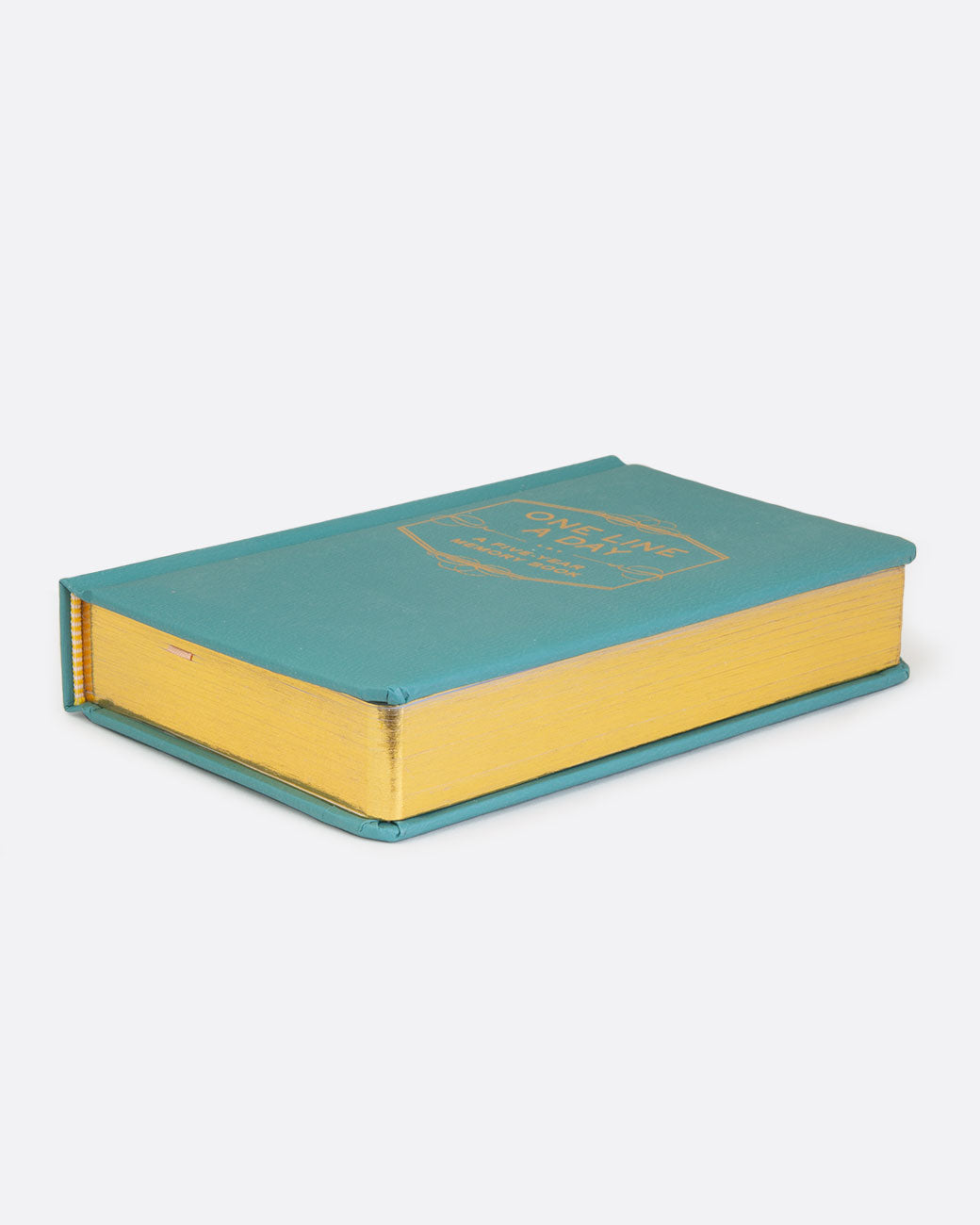 A teal book with gold pages and gold lettering on the cover reading: ONE LINE A DAY... A FIVE- YEAR MEMORY BOOK. Shown lying flat from the side.