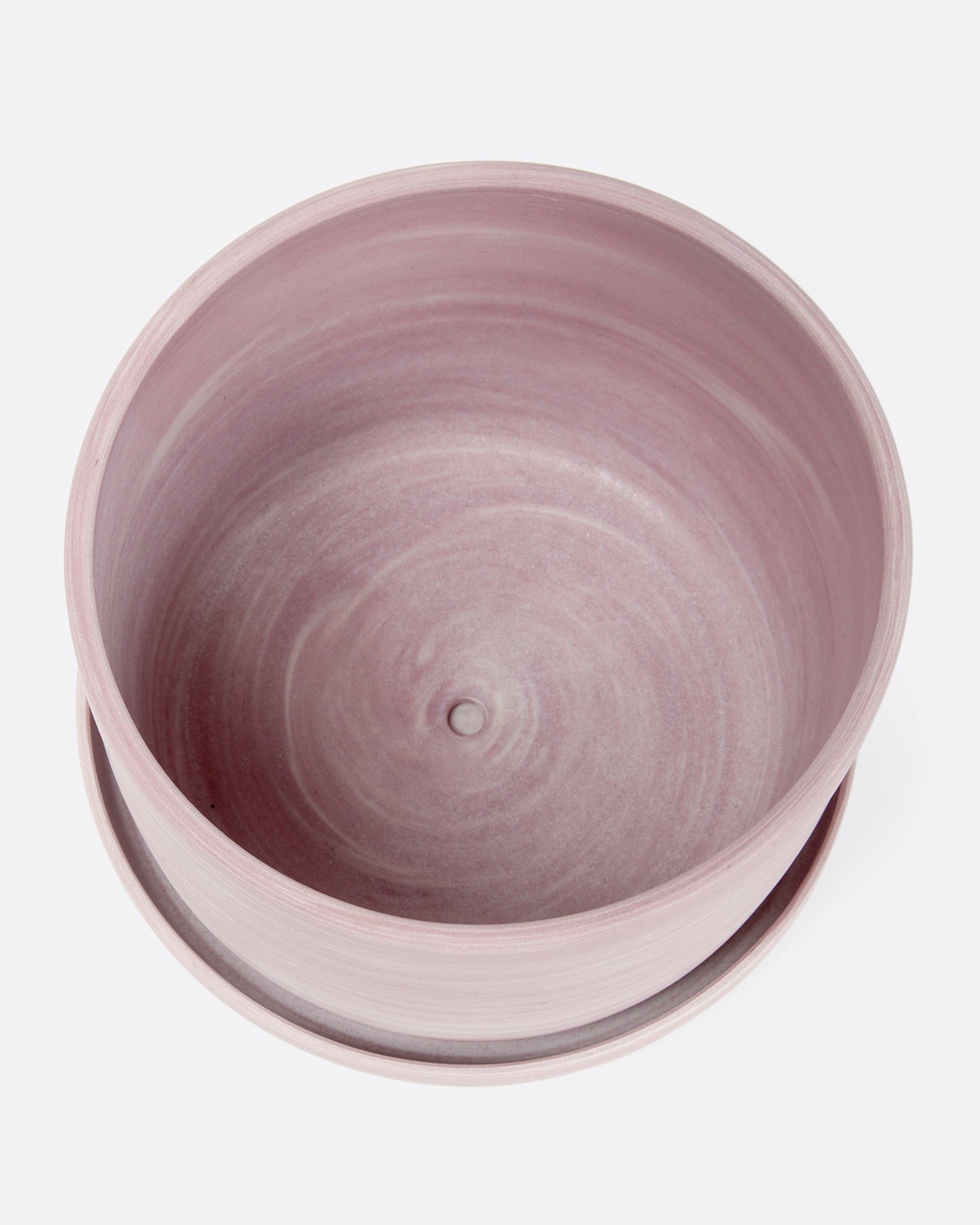 A pink porcelain planter with a matching saucer. Shown from the top.