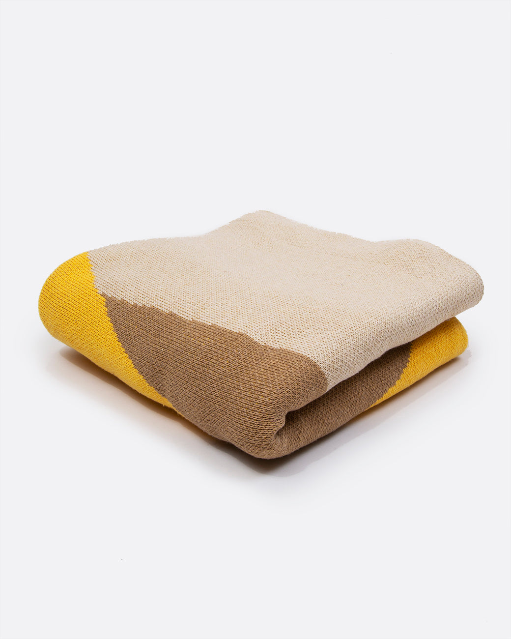 A folded yellow, tan, and brown blanket. Shown at all angle.