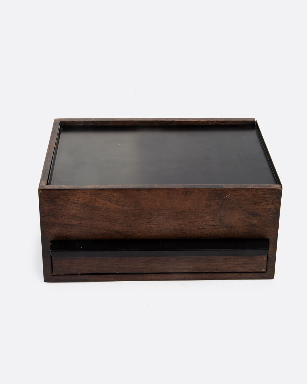 A wooden jewelry box with metal details with a drawer in the front. Shown from the front.