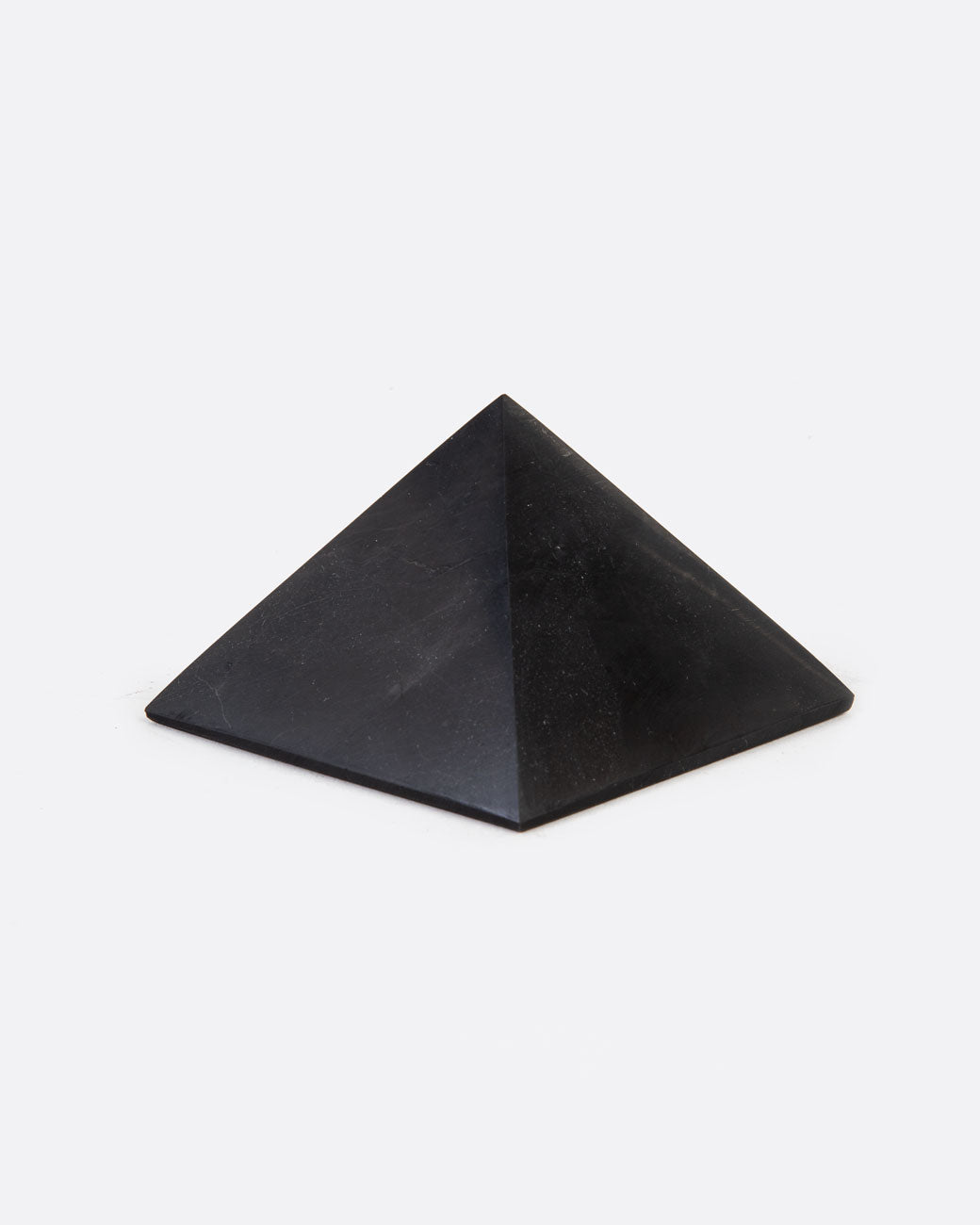 A black stone pyramid. Shown sitting flat at an angle.