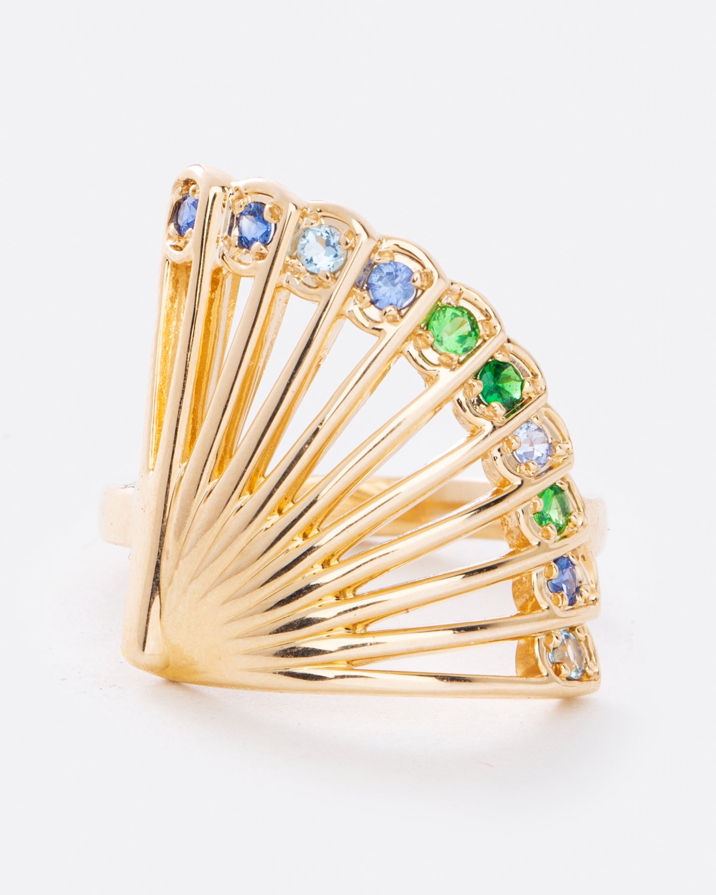 A yellow gold ring in the shape of a fan with multicolor sapphires along the top edge. Shown from the front.