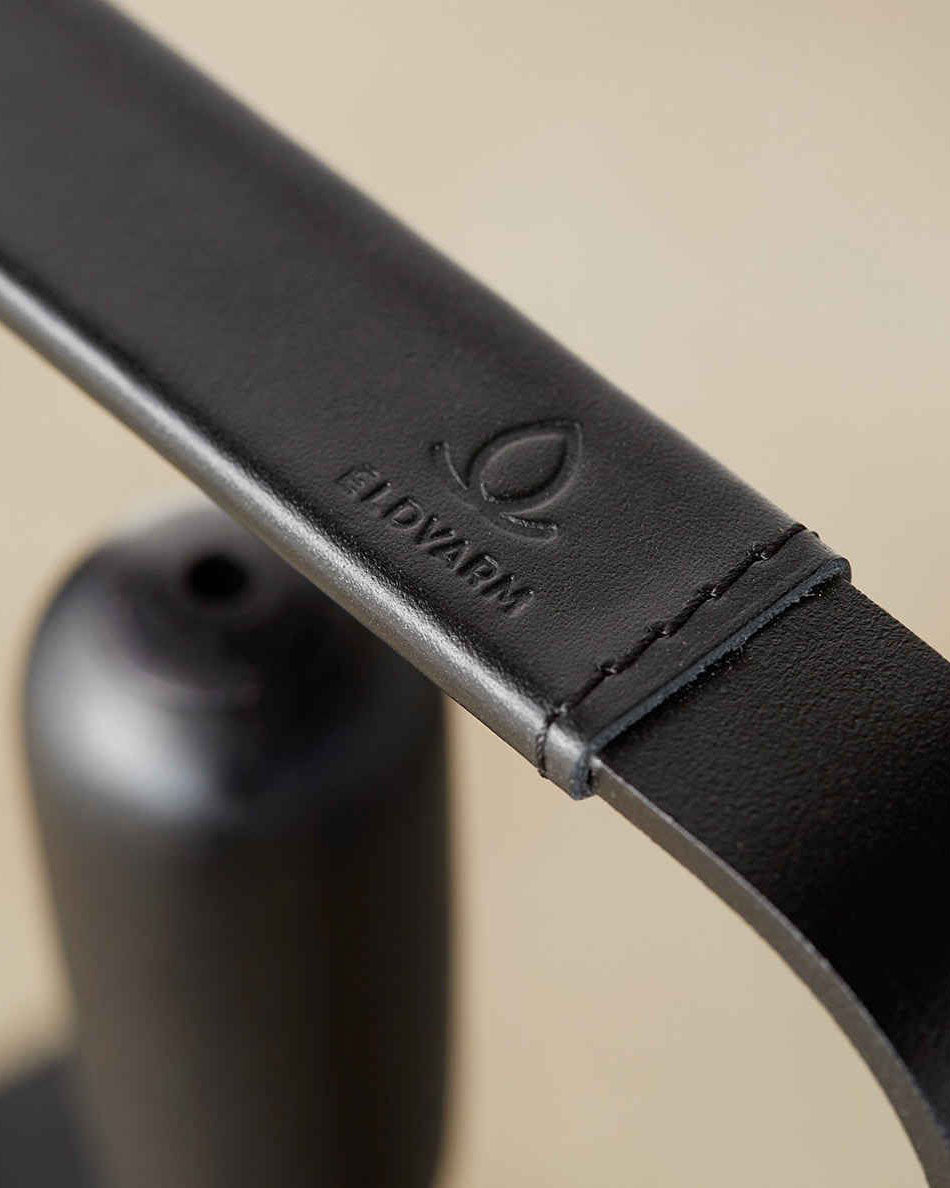 A close up of the detail of the leather on the handles of fireplace tools. Shown from the top.