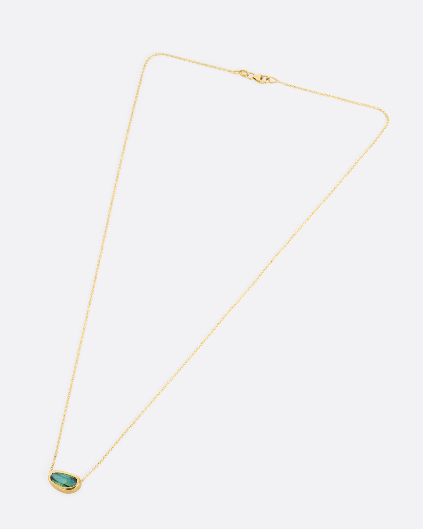 A yellow gold cable chain necklace with a blue-green Australian opal Shown from the front.