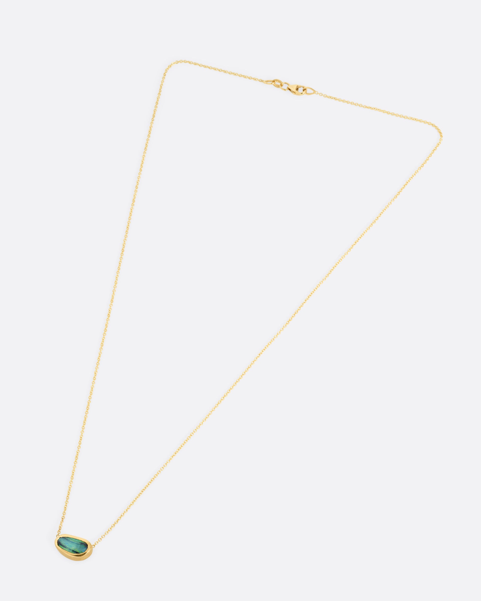 A yellow gold cable chain necklace with a blue-green Australian opal Shown from the front.