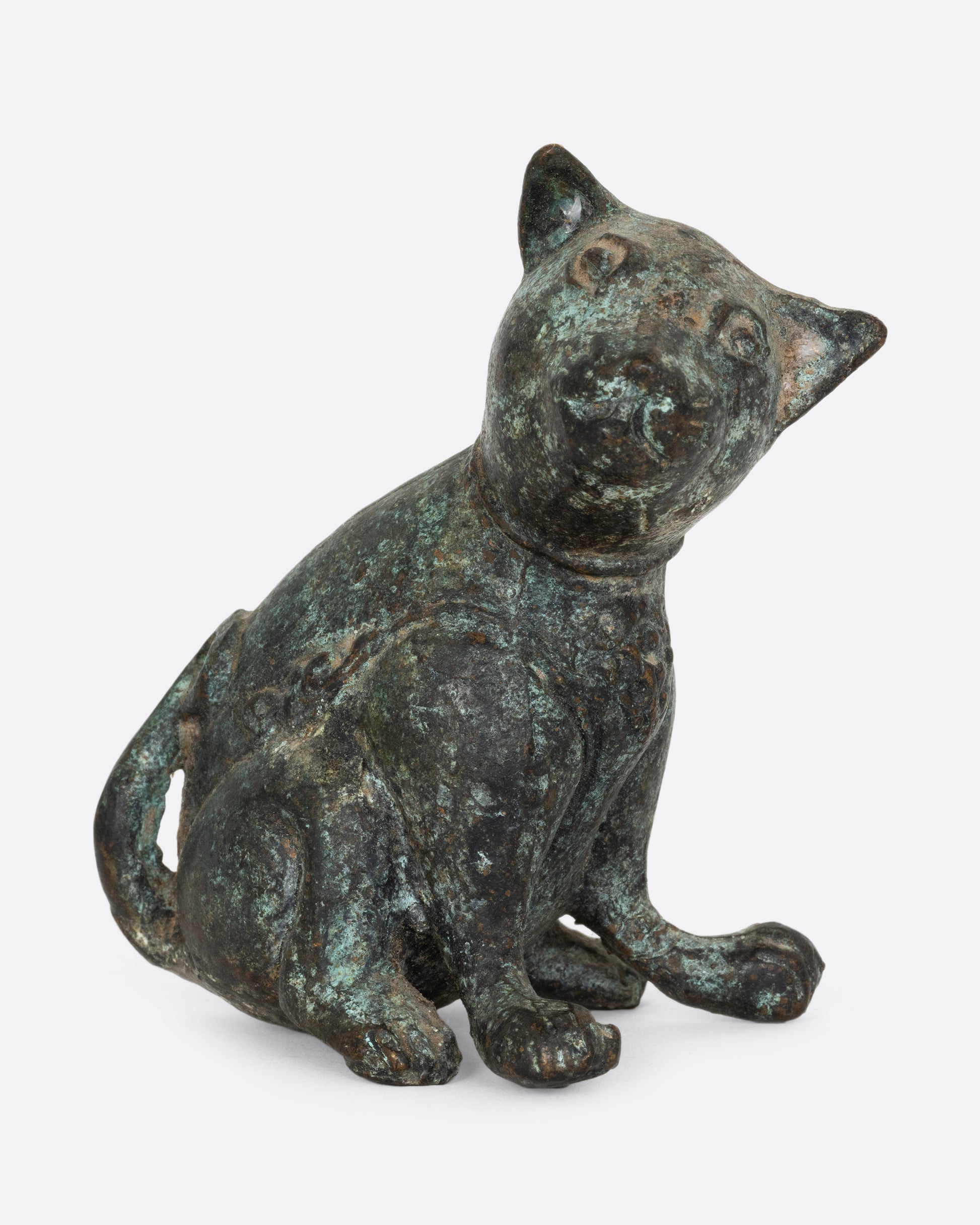 An antique cast iron dog, shown from the front.
