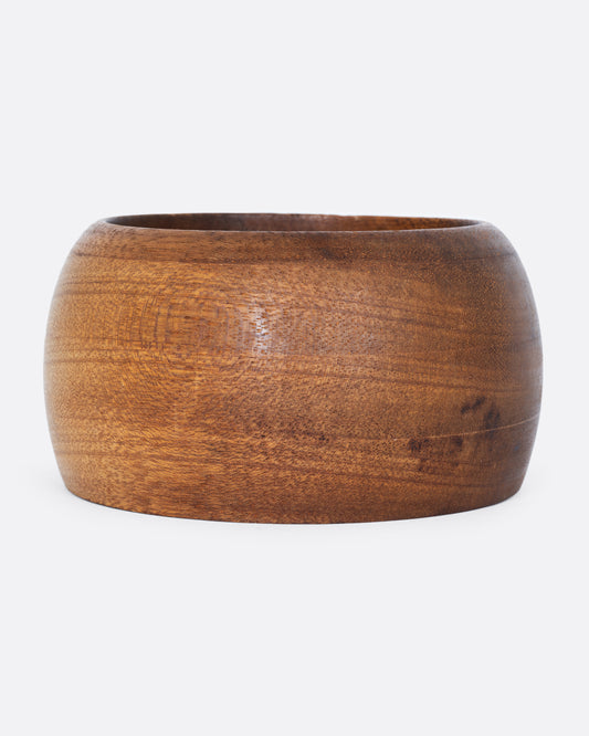 A wooden bowl shown from the side.