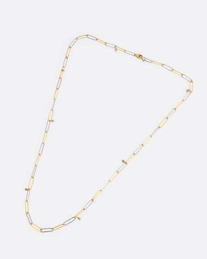 Yellow and white gold paperclip chain necklace with diamonds laid flat, showing the full length