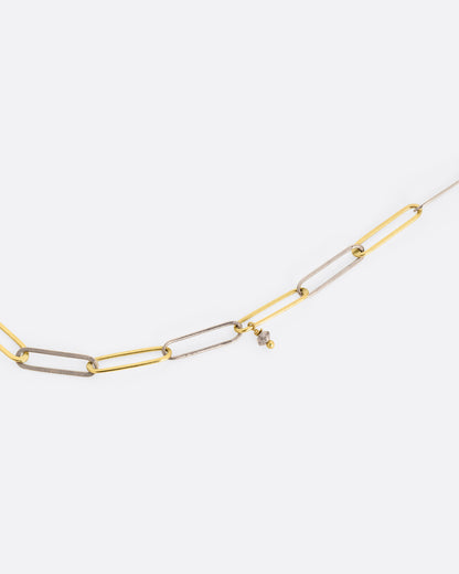 Yellow and white gold paperclip chain necklace with diamonds, close view of the alternating gold links and a diamond bead
