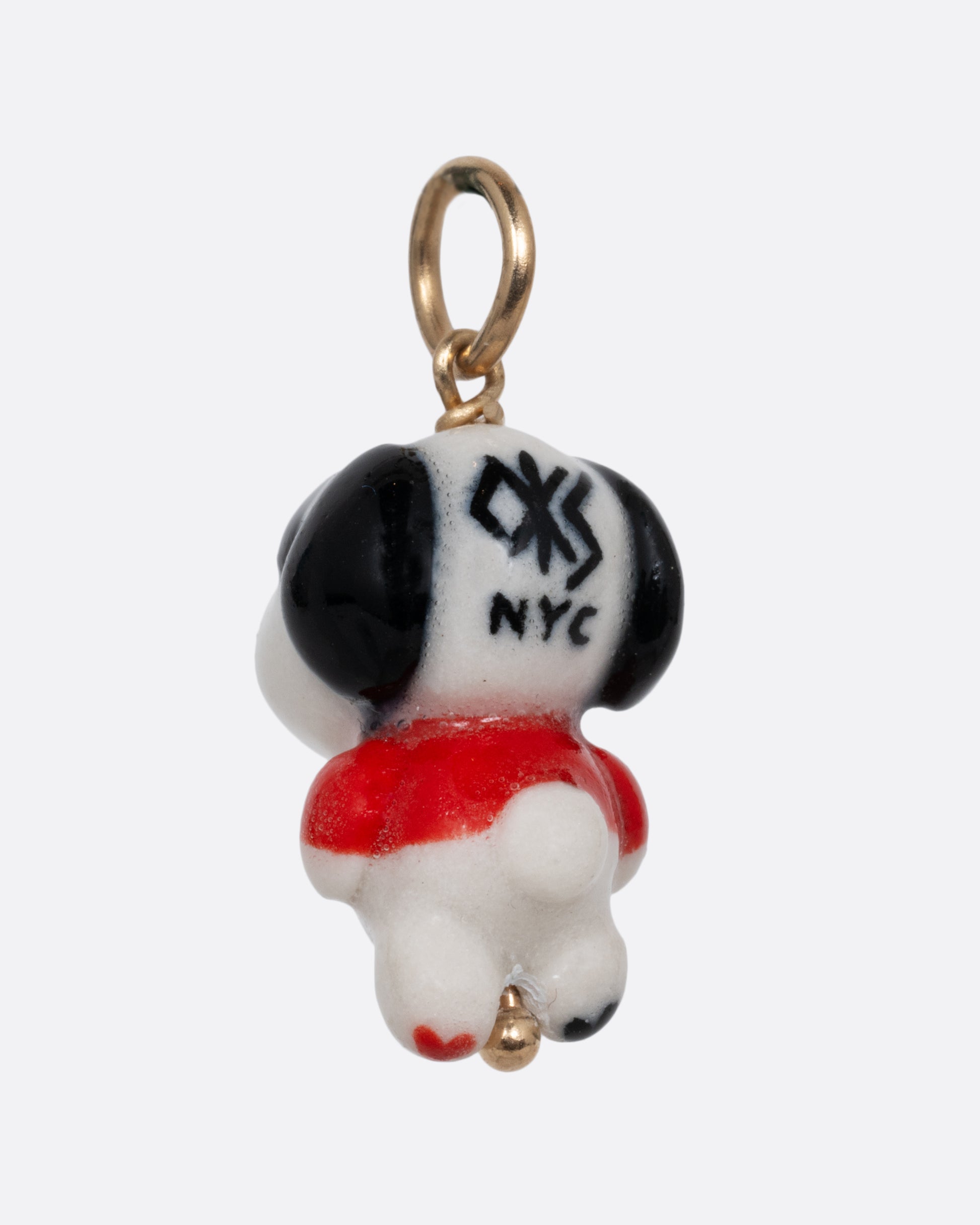 A "Joe Cool" porcelain Snoopy charm with a yellow gold bail. Shown from the back.