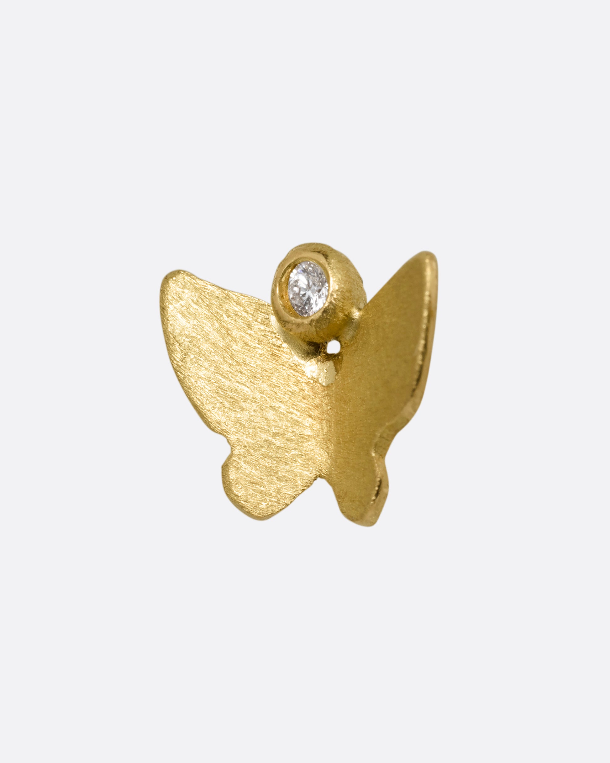 A yellow gold butterfly earring with a single diamond. Shown from the front.