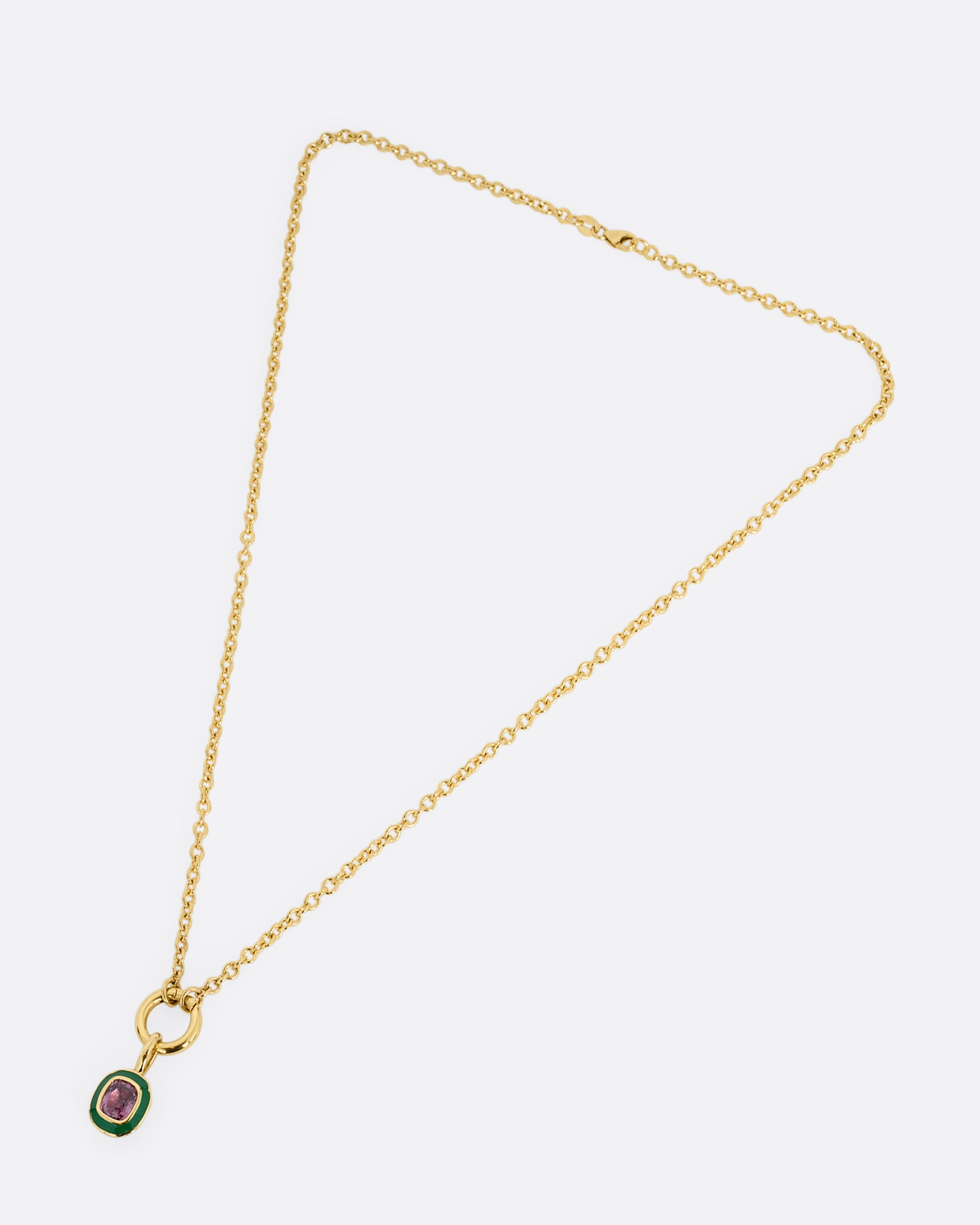 yellow gold pink sapphire pendant with enamel shown from afar