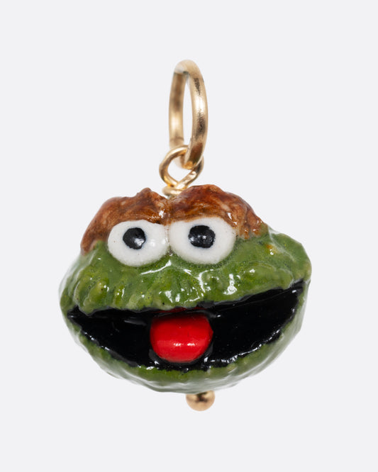 A green Oscar the Grouch porcelain charm with a yellow gold bail. Shown from the front.