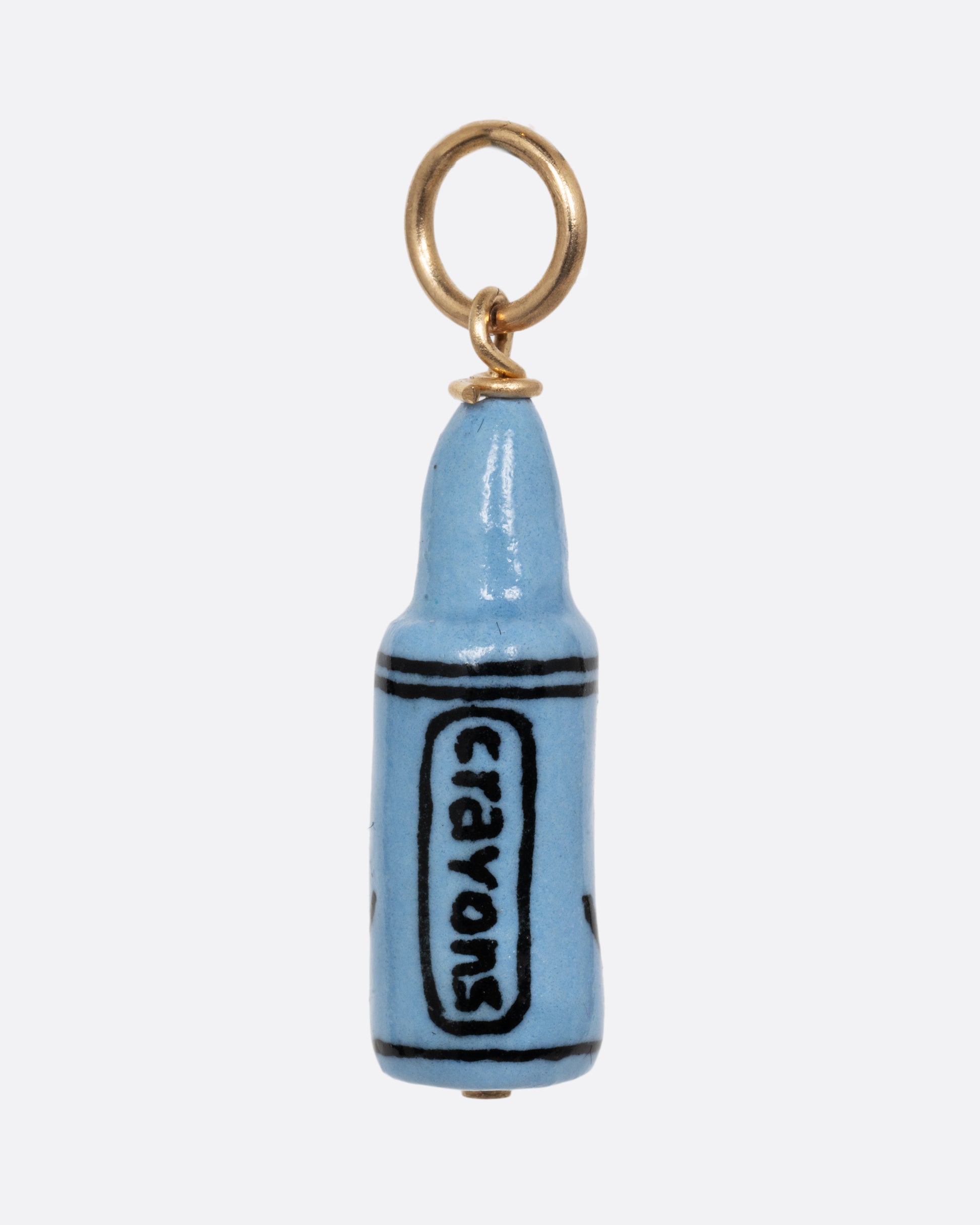 A blue crayon porcelain charm with a yellow gold bail. Shown from the back.
