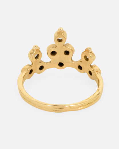 A yellow gold tiara ring with white and black diamonds, shown from the back.