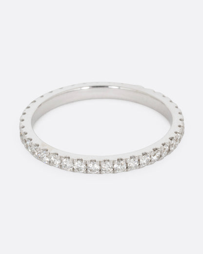 White gold diamond eternity band, front view of the diamond row