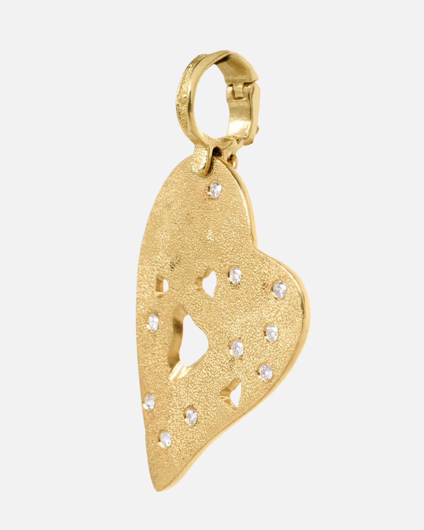 A yellow gold heart shaped pendant with diamond accents. Shown from the side.