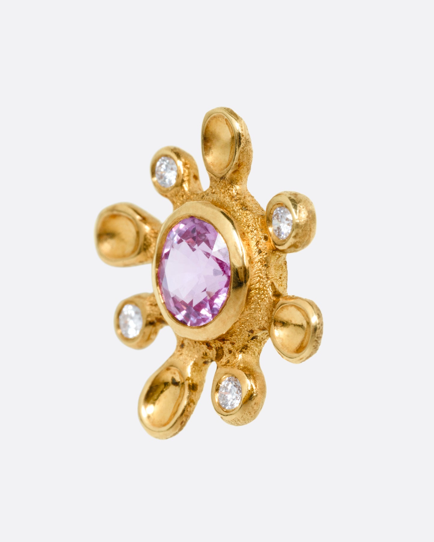 A yellow gold diamond and sapphire flower stud earring. Shown from the side.