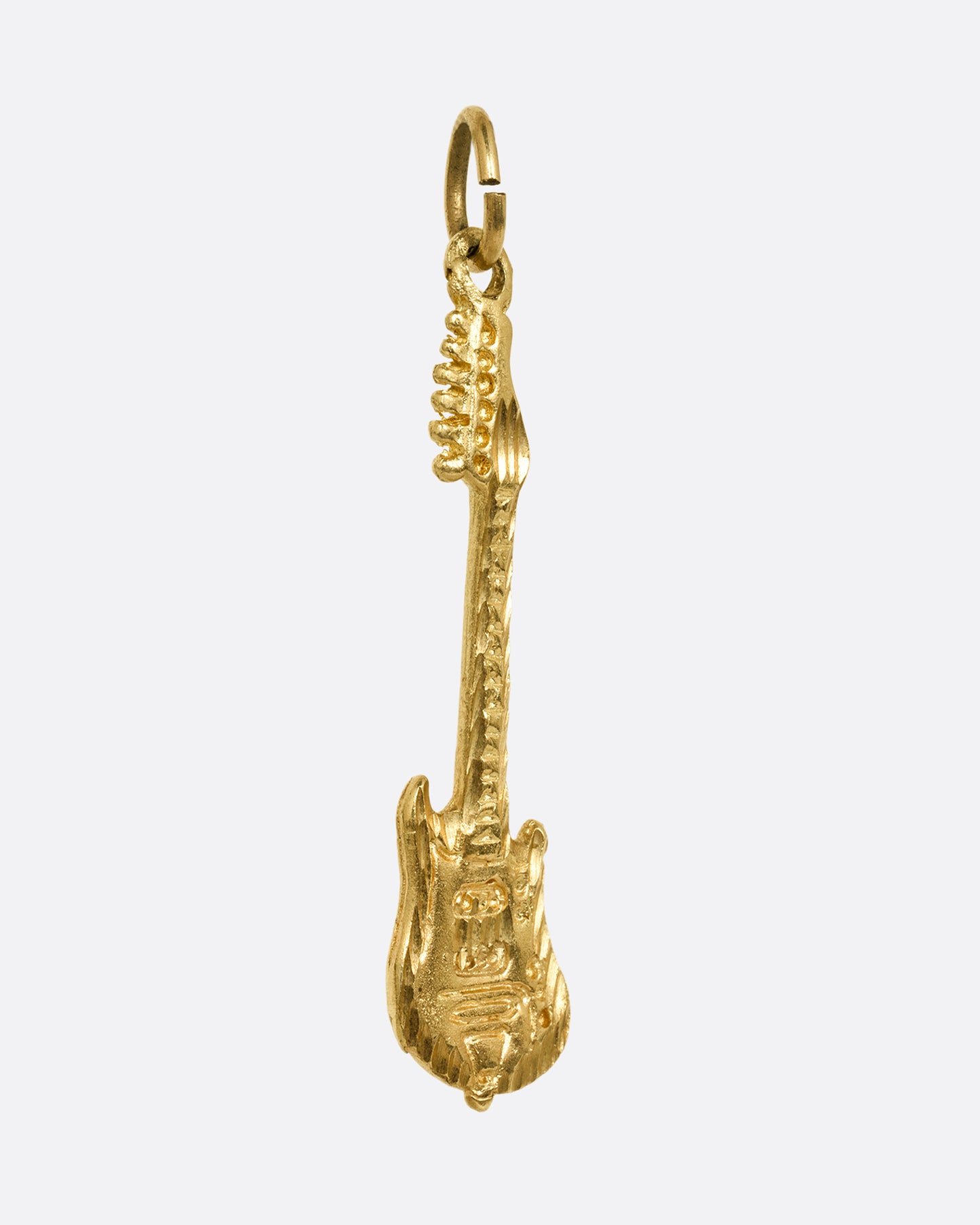An electric guitar charm in yellow gold. Shown from the side.
