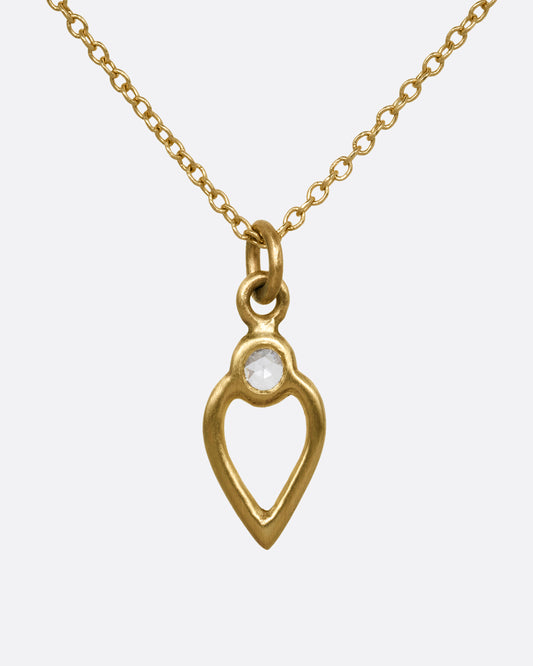 A yellow gold necklace with an open heart pendant with a diamond. Shown from the front.