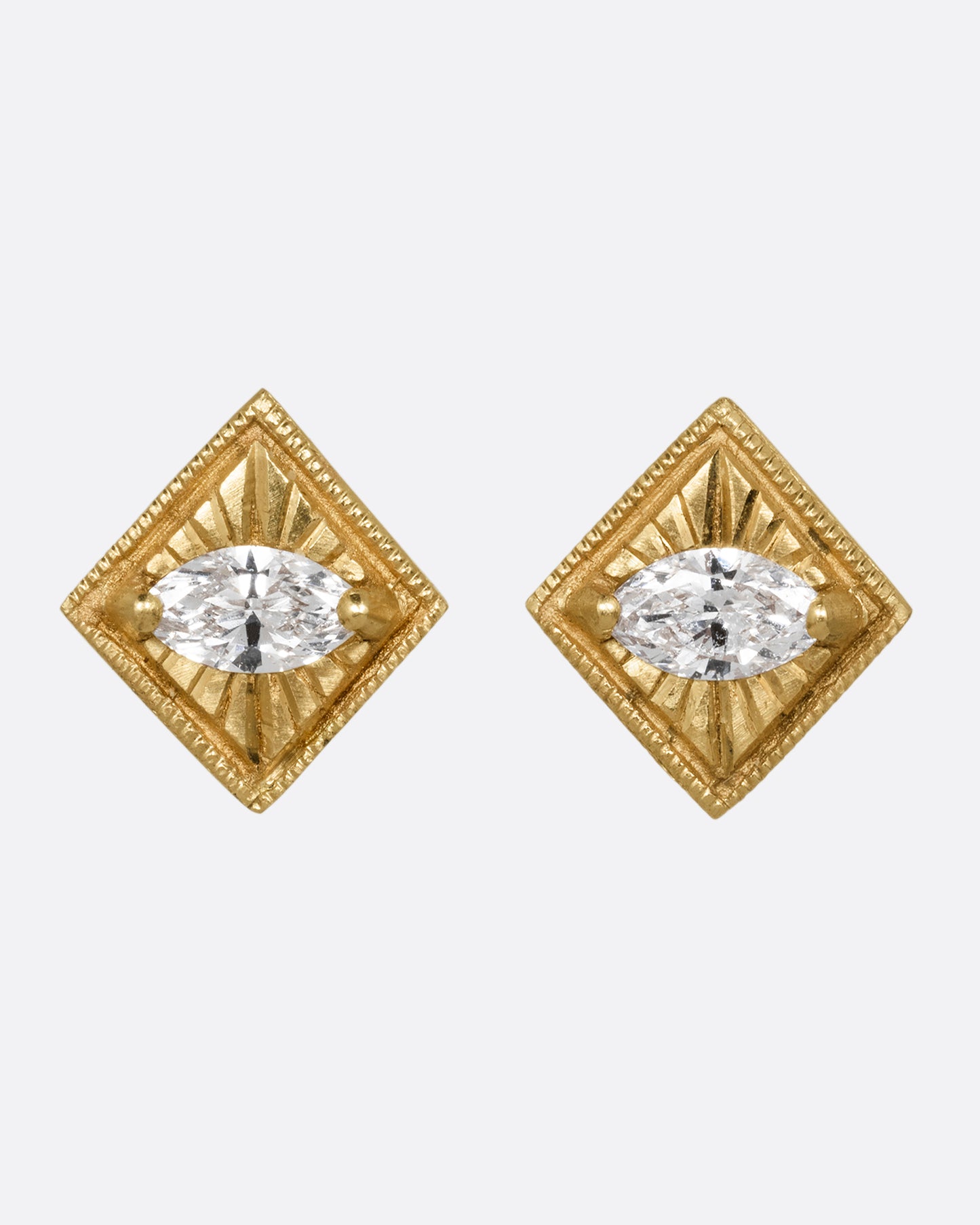 A pair of yellow gold square earrings with a milgrain border and marquis diamond in the center. Shown from the front.