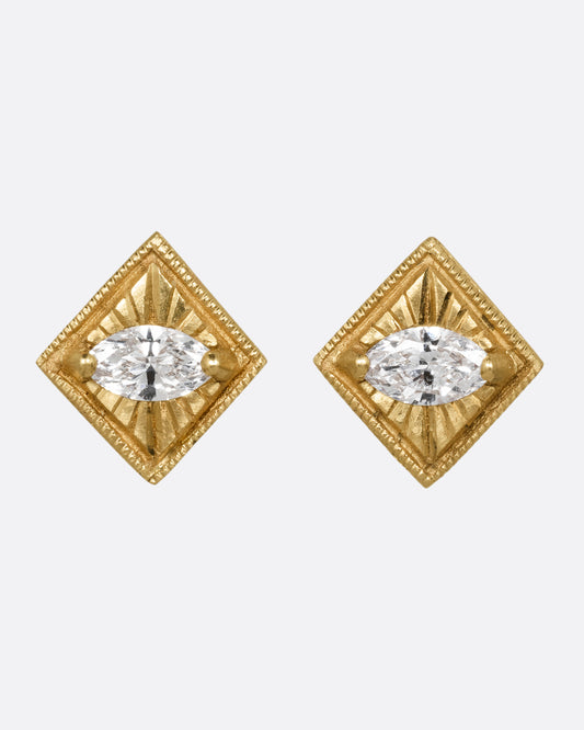 A pair of yellow gold square earrings with a milgrain border and marquis diamond in the center. Shown from the front.